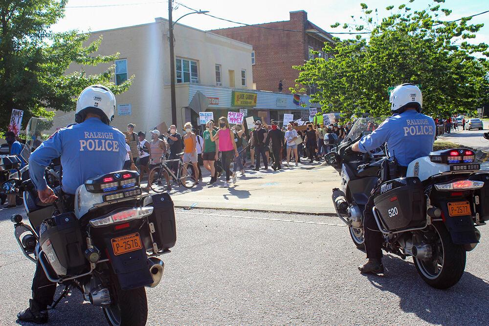 Protesters march on Hillsborough Street as police officers watch on Monday, June 1, 2020. The protest was peaceful during its duration.