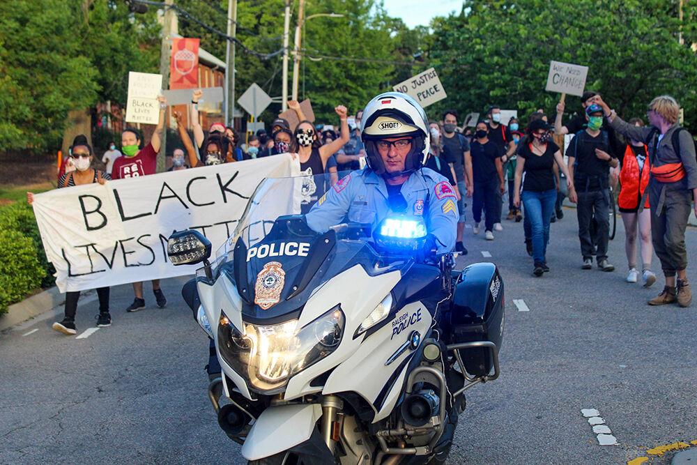 A police officer rides in front of the Black Lives Matter protest in Raleigh on Monday, June 1, 2020.