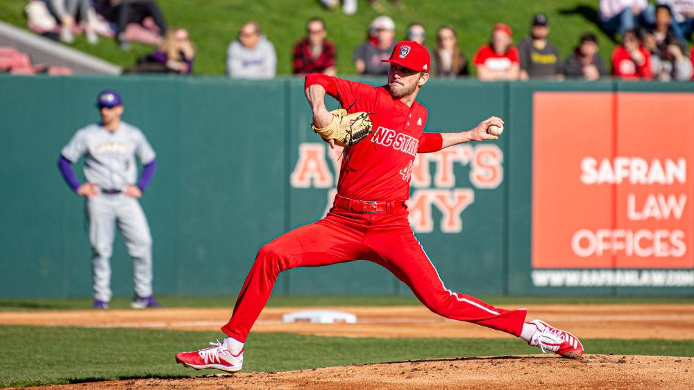 Junior pitcher Nick Swiney delivers the ball against James Madison on Friday, Feb. 14, 2020 at Doak Field. Swiney pitched seven innings, striking out 11 while giving up two hits and two walks. The Wolfpack won the season-opener 4-0.
