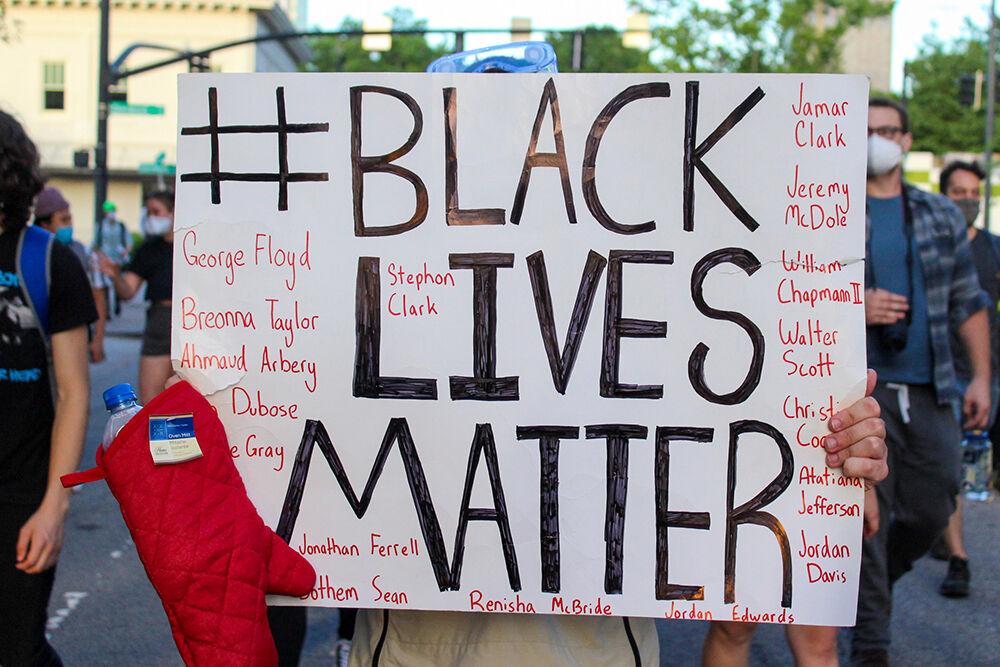 A protester holds a sign during the Black Lives Matter protest in Raleigh in Monday, June 1, 2020. The names on the sign are of African Americans who were unjustly murdered.
