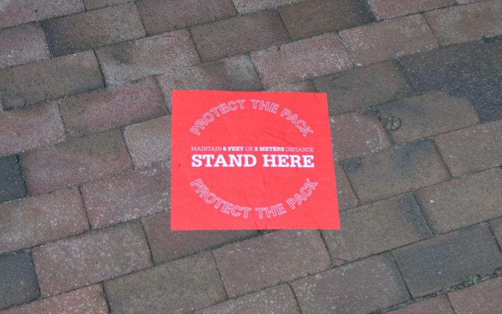 Stickers show people where to stand while waiting in line at Fountain Dining Hall.
