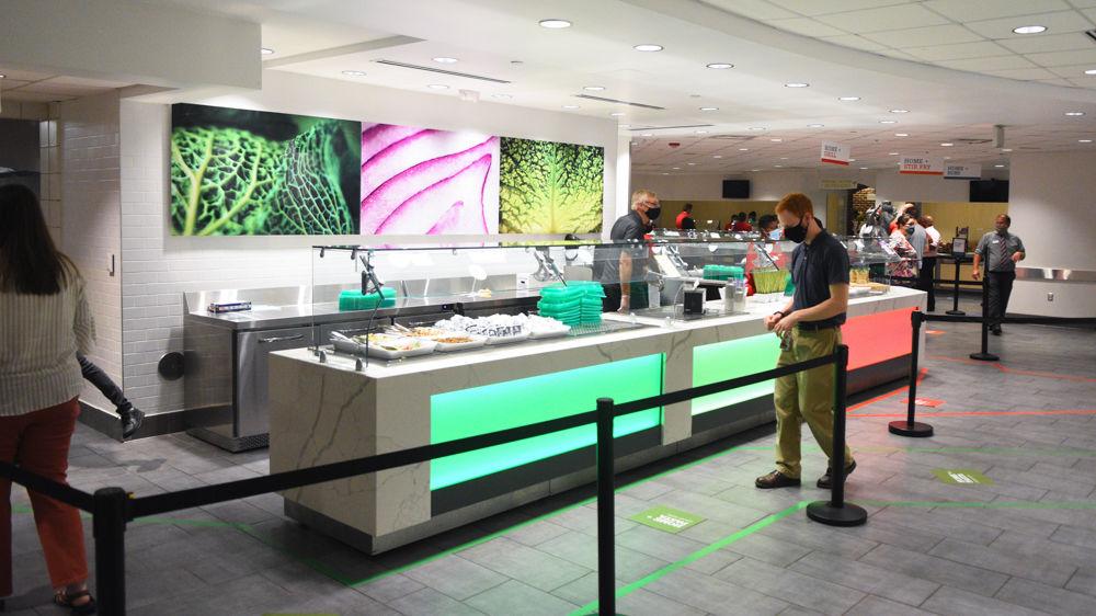 Colored tape and displays show people which lines to stand in for their food.