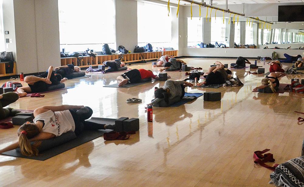 Yoga class attendees follow instruction from Kiera Jonson, a senior in microbiology, during a restorative yoga class on Saturday, Feb 8. 2020 in Carmichael Gym.