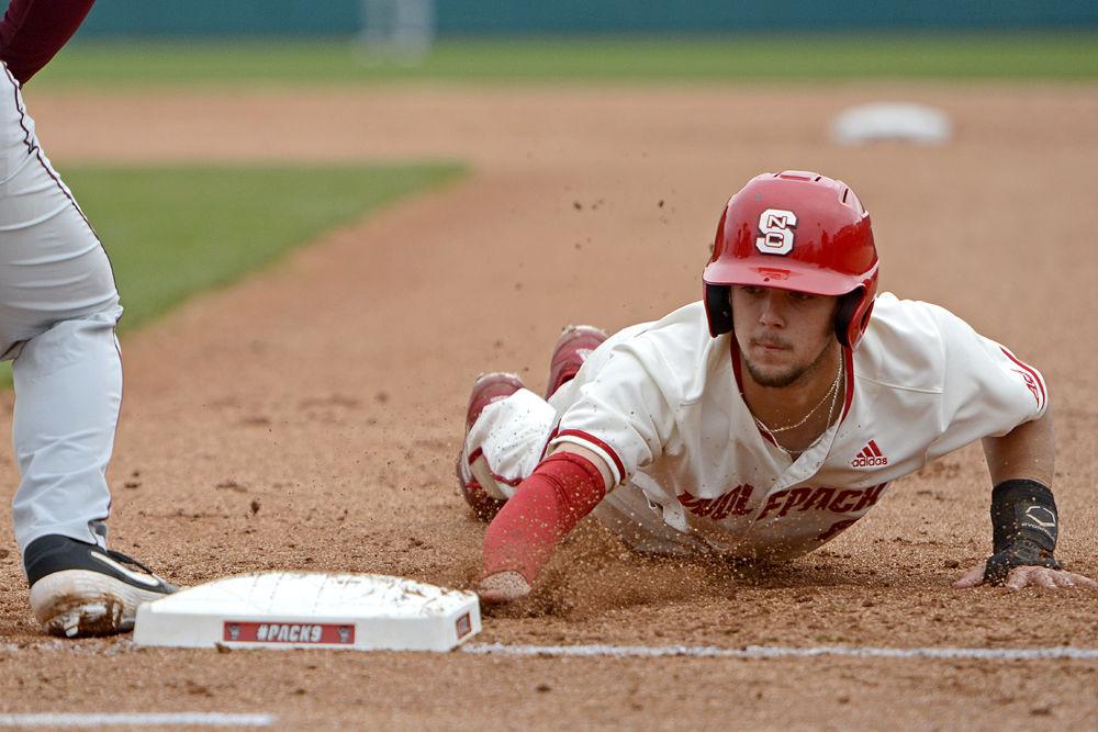 Junior infielder Will Wilson dives back to first base to avoid being picked off by Minnesota on Sunday, March 3, 2019. Wilson went 0-3 with one run batted in and one walk. The Wolfpack won 5-4 via junior catcher Brad Debo&#8217;s walk-off base hit.