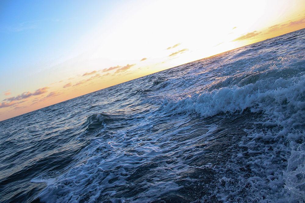 The sun rises over the wake of a boat 3 miles off the coast of Stuart, Florida on Tuesday, June 30, 2020.