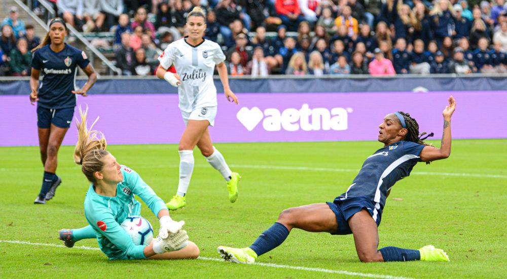 NC Courage forward Crystal Dunn lunges toward the ball against Reign FC goalkeeper Casey Murphy on Sunday, Oct. 20 at WakeMed Soccer Park. Dunn scored one goal and had five shots on goal as the Courage won 4-1 to advance to the NWSL championship final.