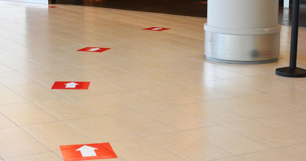 Markings on the ground show students where to stand while waiting to pick up food.