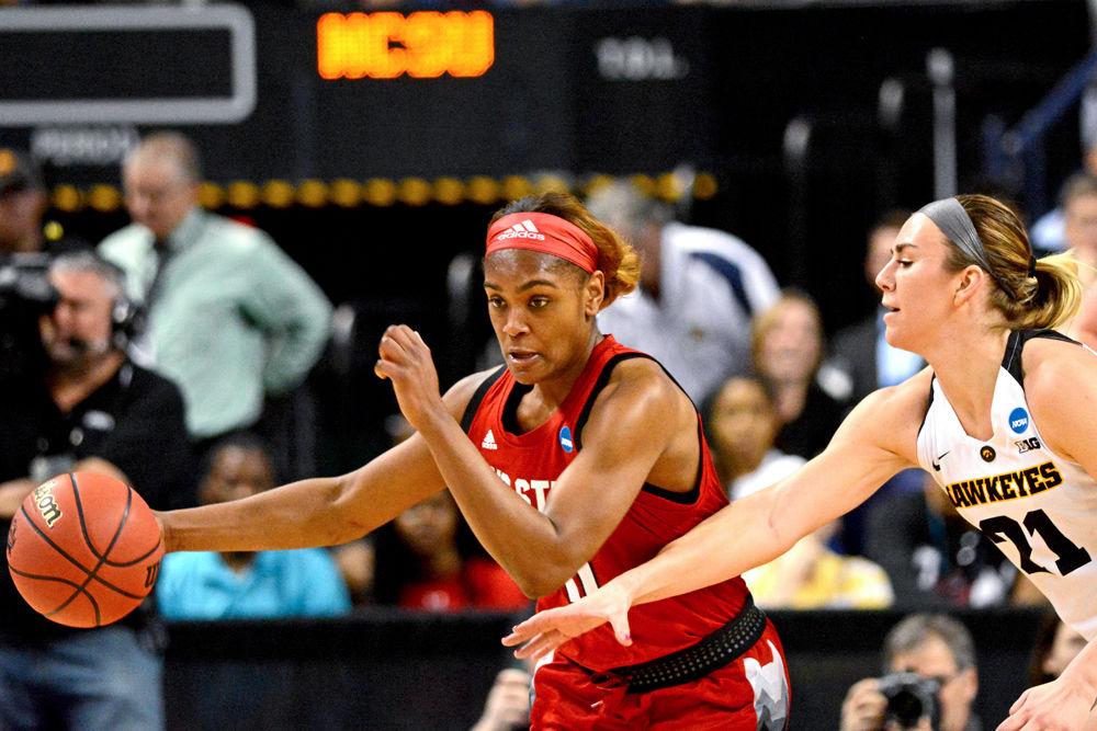 Redshirt senior guard Kiara Leslie dribbles past Iowa forward Hannah Stewart after securing a loose ball on Saturday, March 30, 2019 at Greensboro Coliseum. Leslie recorded 16 points and nine rebounds as the Wolfpack lost to the Hawkeyes 79-61.