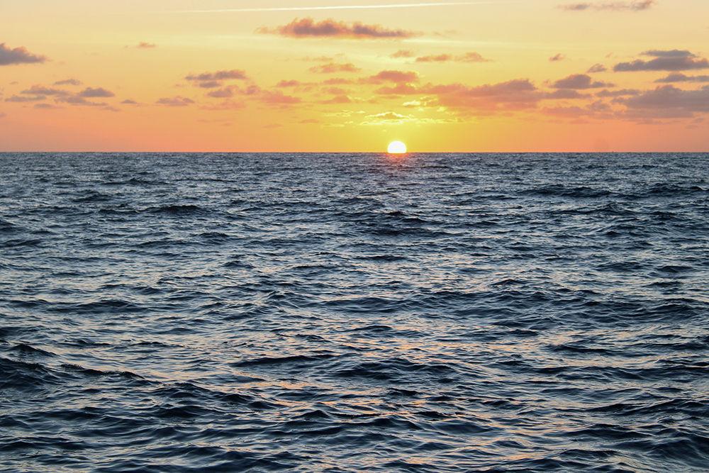 In an archive photo from Tuesday, June 30, 2020, the sun rises over the water 3 miles off the coast of Stuart, Florida.