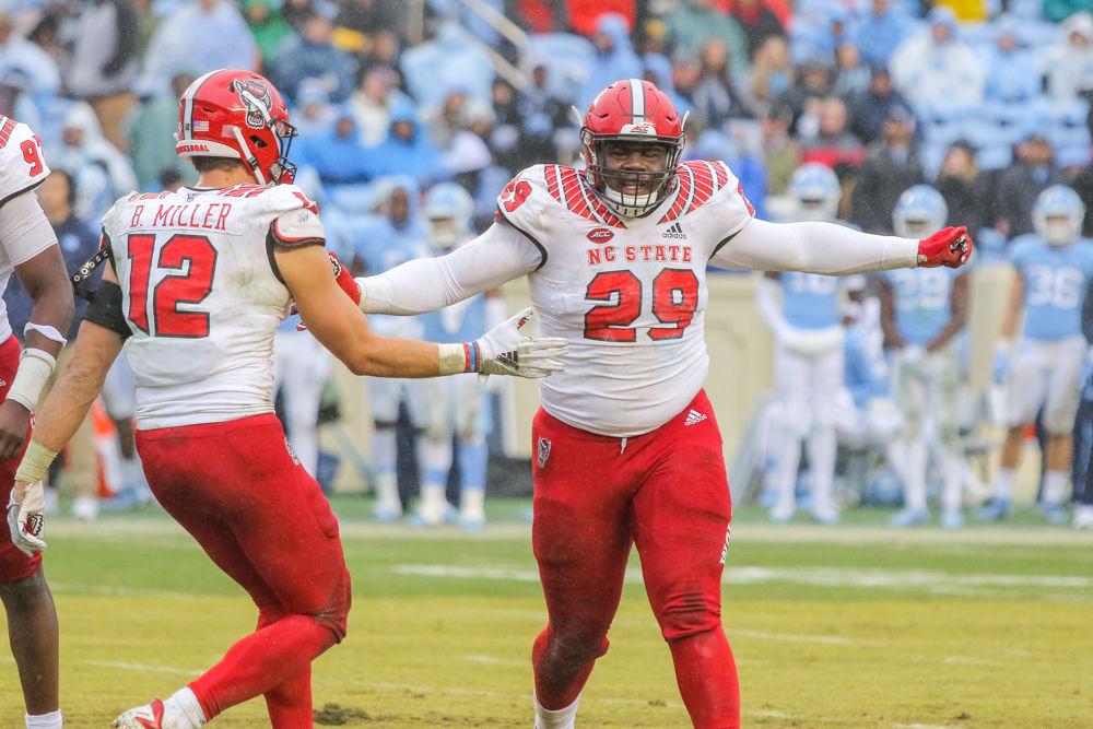 Freshman defensive tackle Alim McNeill rushes toward redshirt sophomore linebacker Brock Miller after a big play. McNeill had the lone sack on the day for the Pack. The Wolfpack were tested by the Tar Heels, but came away with a 34-28 overtime win on Saturday, Nov. 24 in Kenan Memorial Stadium.