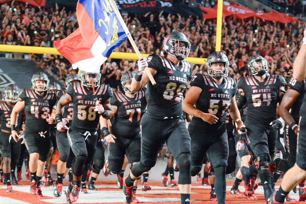 The NC State Wolfpack run out onto the field at Carter-Finley Stadium before the game against Louisville. After putting up 520 total yards of offense, the Wolfpack won 39-25 against the Cardinals on Thursday, Oct 5.