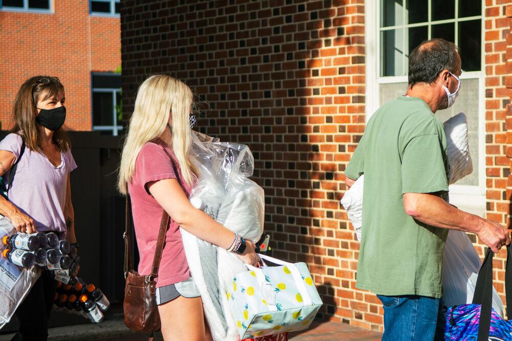 Grace Hite, a first year in exploratory studies, moves in belongings along with her parents during move in on Saturday, Aug. 1, 2020. Students were given masks when arriving on campus as part of their welcome packet.