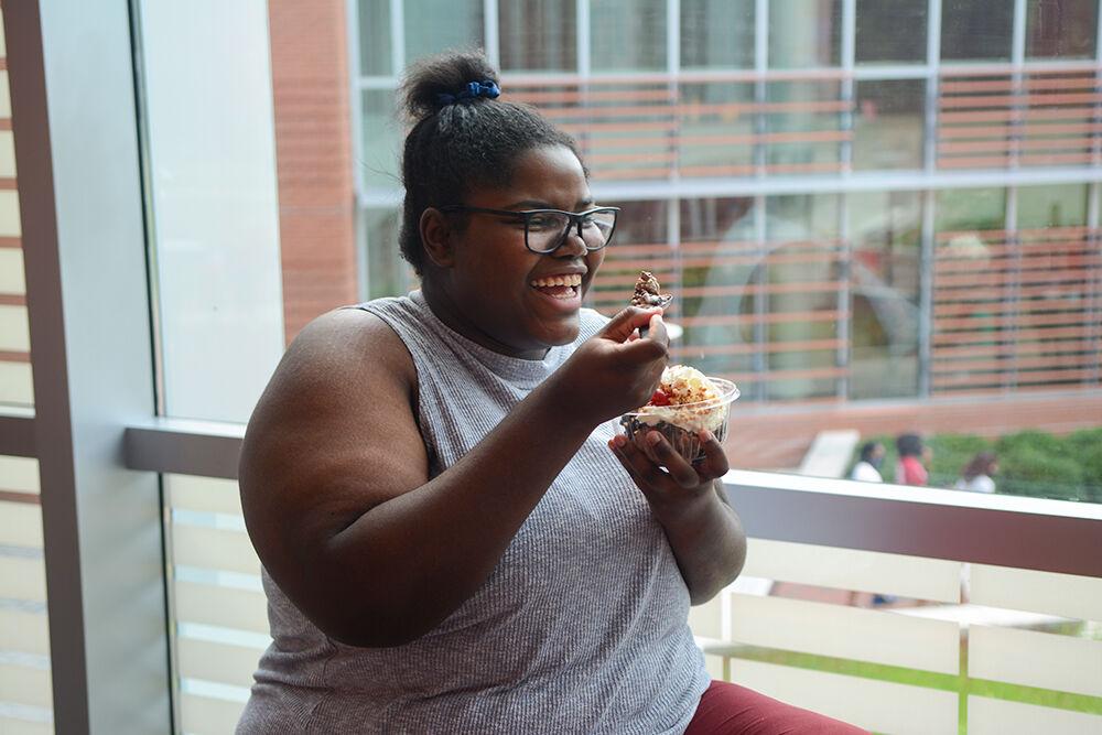 Maria Lanier, a second year is studying biology, eats a Howling Cow sundae in Talley Student Union on Saturday, Aug. 8, 2020. Her and her friends decided to purchase Howling Cow due to the humid weather outside. Howling Cow ice cream parlor's new hours include Wednesday through Sunday from 3pm to 8pm.