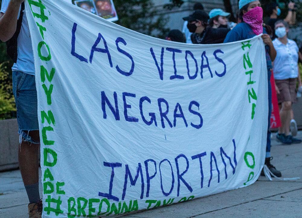 Protestors hold up a sheet with Spanish writing during the Black Lives Matter protest in downtown Raleigh on Friday, Aug. 28, 2020. The text on the sheet translates to "Black Lives Matter."