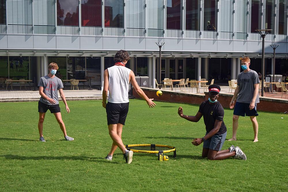 Jeremy Ugwuegbu, a junior studying mechanical engineering, Noah Graham, a senior studying mechanical engineering, Tommy Drake, a sophomore studying business administration, Owen Loker, a freshman in First Year Engineering, play Spike Ball outside of Talley Student Union on Saturday, Aug 8, 2020. Drake, an Resident Advisor on main campus, says it's up to the freshman to prevent the spread of COVID.&#160;