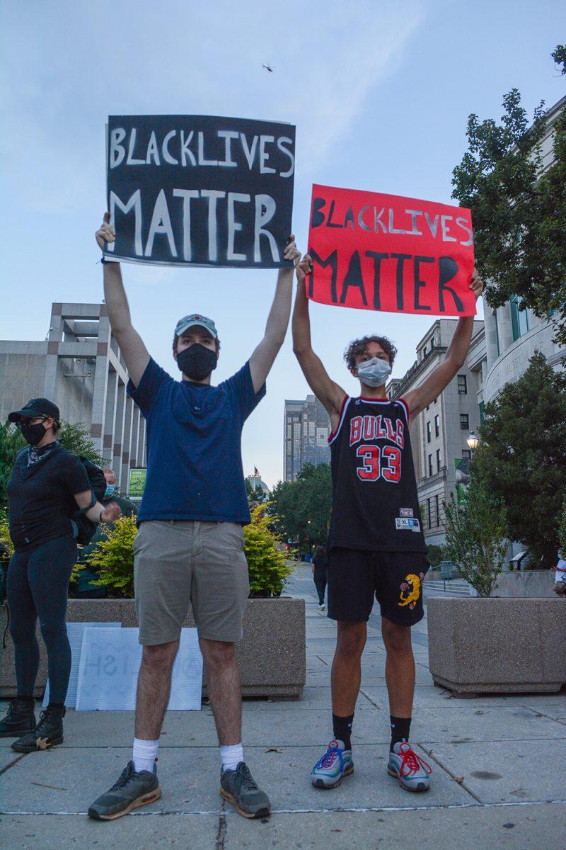 Oscar Upshaw and Tenzin Faulkner, both students at Northwood High School in Pittsboro, North Carolina, hold signs in solidarity at the Black Lives Matter Community March downtown Raleigh on Friday, Aug. 28, 2020. The march demanded an end to police brutality, and honored those murdered by the police.