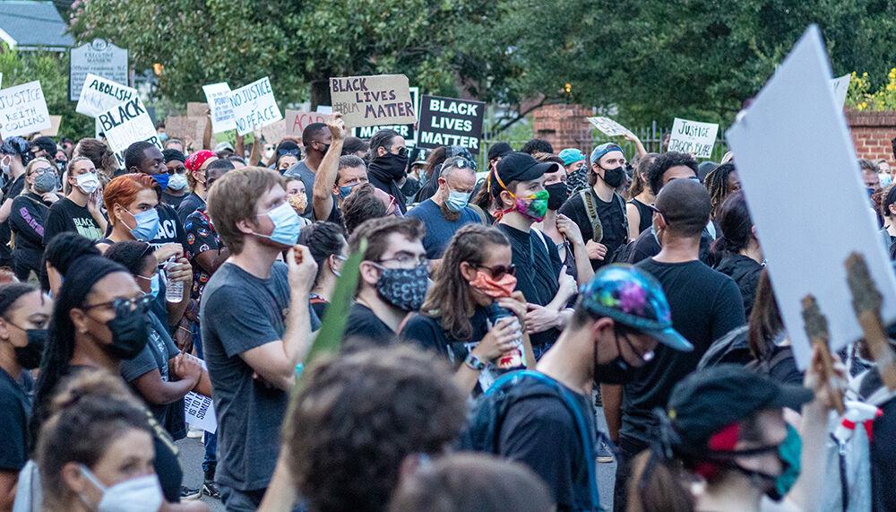 Protesters gather in front of the Executive mansion in dowtown Raleigh on Friday, Aug. 28, 2020. The Executive mansion, which is the residence of the governor of North Carolina, was one of the stops made during the march.