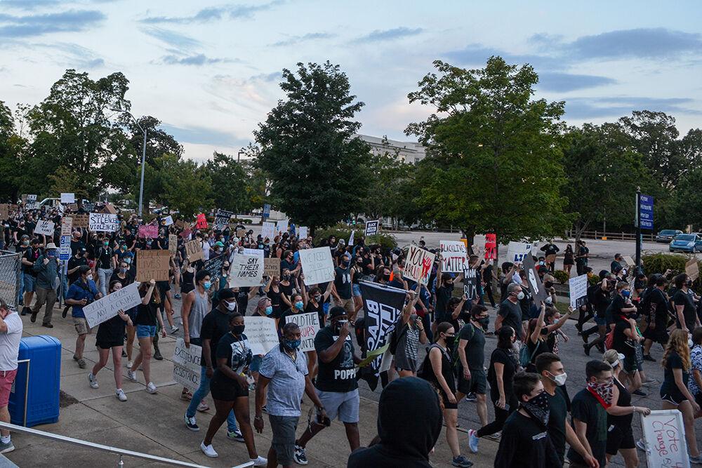 A crowd of protesters march in solidarity at the BLM Community March in downtown Raleigh on Friday, Aug. 28, 2020. Marchers carried homemade signs and spoke out the names of the victims of police brutality.