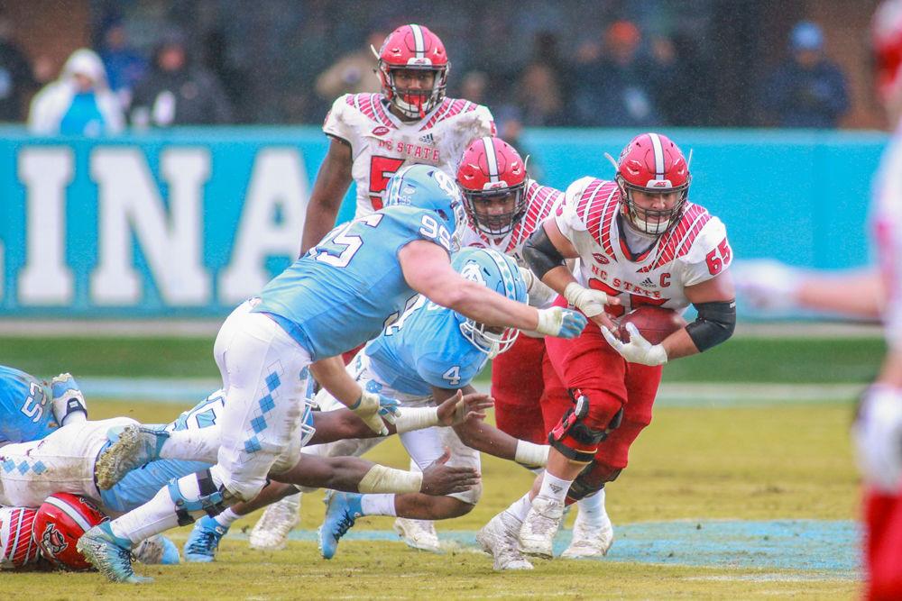 Graduate center Garrett Bradbury picks up the fumble and tries to make the first down. The Wolfpack were tested by the Tar Heels, but came away with a 34-28 overtime win on Saturday, Nov. 24 in Kenan Memorial Stadium.