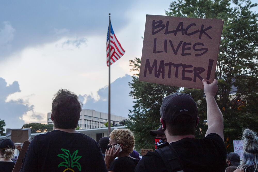 Protesters display signs at the North Carolina State Legislative Building at the Black Lives Matter Community March in downtown Raleigh on Friday, Aug. 28, 2020. The march called for justice for the victims of police brutality.