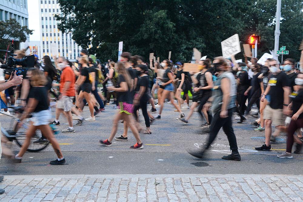Protesters march through the streets of downtown Raleigh at the Black Lives Matter Community March on Friday, Aug. 28, 2020. The the BLM movement has been one of the largest civil rights movements in history with protests occurring throughout the world.