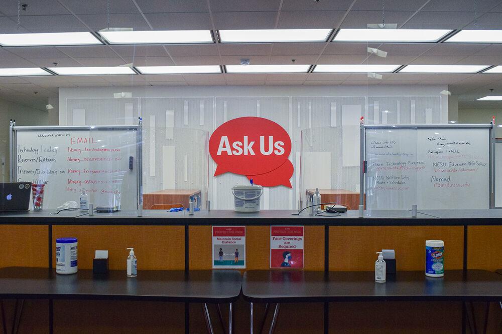 The Ask Us desk at D.H. Hill Library has gotten a makeover to encourage social distancing COVID practices. On Saturday, Aug. 22, 2020, Clorox wipes, hand sanitizer, spray shields, and social distancing tables are observed to keep everyone safe.