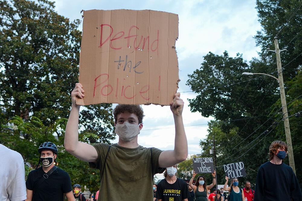 Paul Wynkoop, a research assistant at UNC-Chapel Hill and a Durham native, marches alongside his friends and other protesters members at the Black Lives Matter Community March downtown Raleigh on Friday, Aug. 28, 2020. The march called for reforms within the Raleigh Police Department, and brought awareness to the victims of police brutality throughout America.