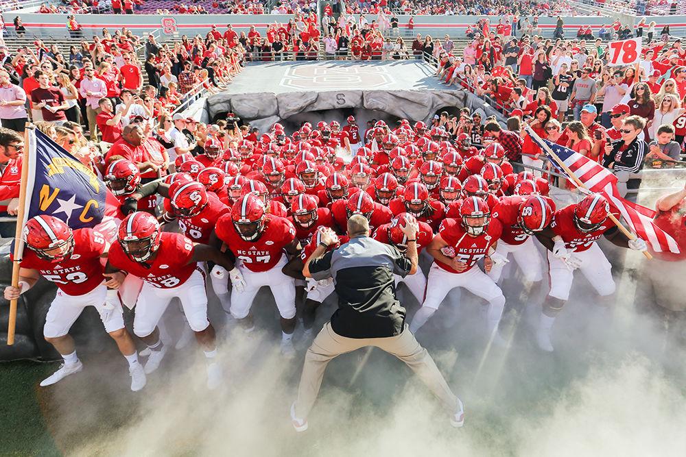 Head coach Dave Doeren sways with the team before taking the field in the 27-13 loss to Miami on Nov. 19, 2016 at Carter-Finley Stadium.