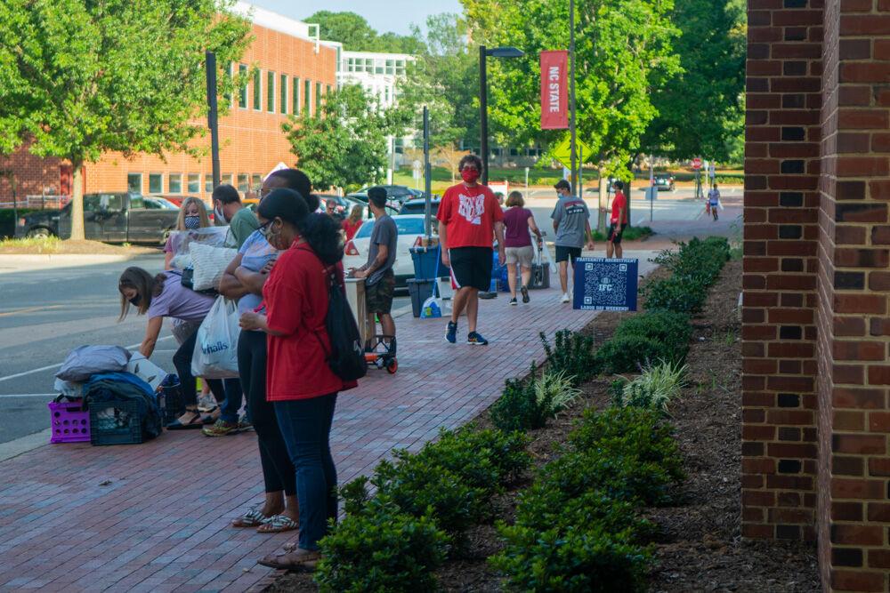 Students and their families unload belongings on the curb next to Tucker Residence Hall on Saturday., Aug. 1, 2020. Students were assigned move in slots to allow for social distancing within the dorms.