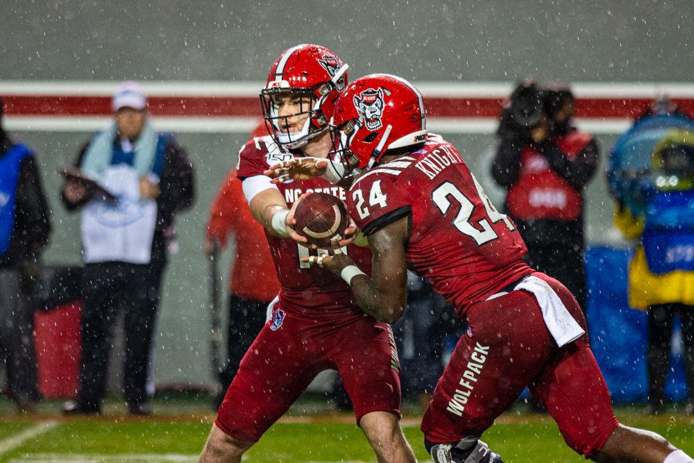 Redshirt freshman quarterback Devin Leary hands off the ball to Freshman running back Zonovan Knight versus UNC on Saturday, Nov. 30, 2019 at Carter-Finley Stadium. Leary threw for 98 yards with one touch down and Knight had 56 yards in the 41-10 win