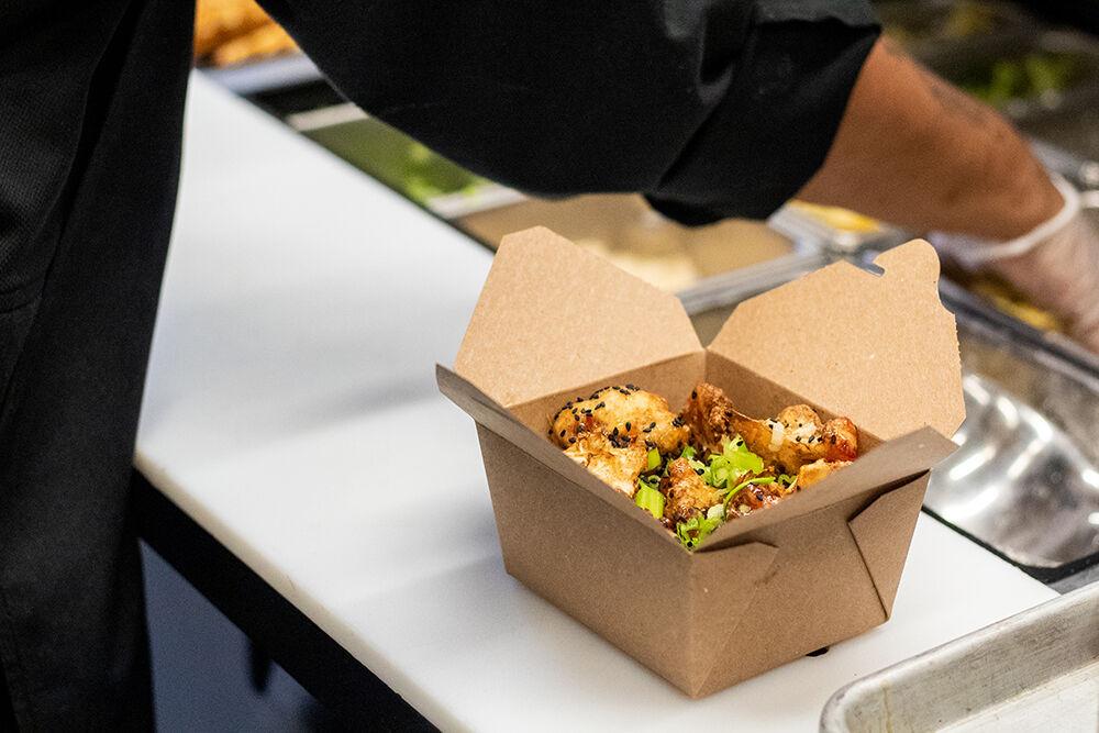 Sweet Thai chili cauliflower sits in a to-go box in the kitchen of the 1887 Bistro on Wednesday, Sept. 23, 2020. 1887 Bistro has made numerous changes in order to still be open during the ongoing COVID-19 pandemic, such as switching to Grubhub orders in place of dining in.