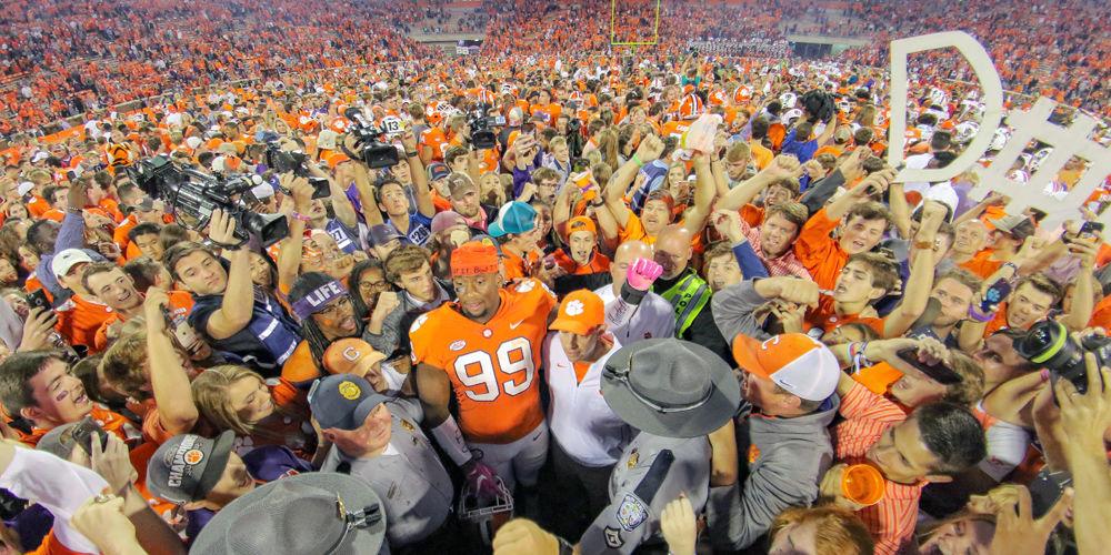 Head coach Dabo Swinney and Clemson defensive end Clelin Ferrell are surrounded by fans after playing NC State at Clemson Memorial Stadium on Saturday, Oct. 20. The Wolfpack lost 41-7.