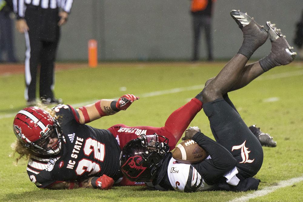 Freshman linebacker Drake Thomas sacks Louisville's quarterback Micale Cunningham on Saturday, Nov. 16, 2019 at Carter-Finley Stadium. Thomas had one sack and five tackles in the game against the University of Louisville. The Pack lost 34-20 to the Cardinals in regulation time.&#160;