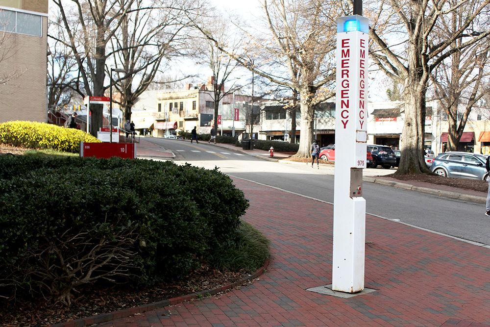 An emergency blue light stands on a corner near the 1911 Building. Blue lights serve as an aid to those who need help in times of emergency. The station quickly allows students to contact NC State University Police.
