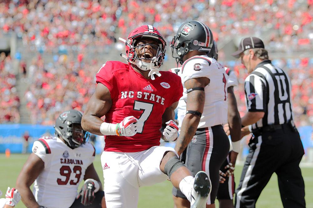Junior running back Nyheim Hines celebrates after breaking through the line for a short touchdown. Hines had 83 yards on 15 carries and the touchdown during the 35-28 loss to South Carolina on Saturday, Sept. 2 in the Bank of America Stadium for the Belk College Kickoff game.