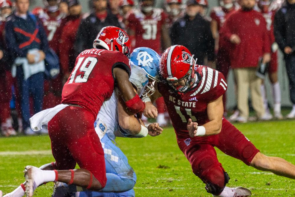 Freshman wide receiver Cecil Powell and Redshirt freshman linebacker Payton Wilson tackle a UNC player on Saturday, Nov. 30, 2019 at Carter-Finley Stadium. Wilson had 14 tackles and one interception and Powell had eight tackles in the 41-10 loss.