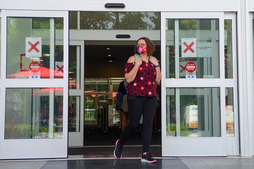 Gabriella Agnello, a graduate student studying physiology, exits D.H. Hill Library on Tuesday, Aug. 18, 2020. Due to the coronavirus pandemic the library is marked with pathways to enter and exit the building.
