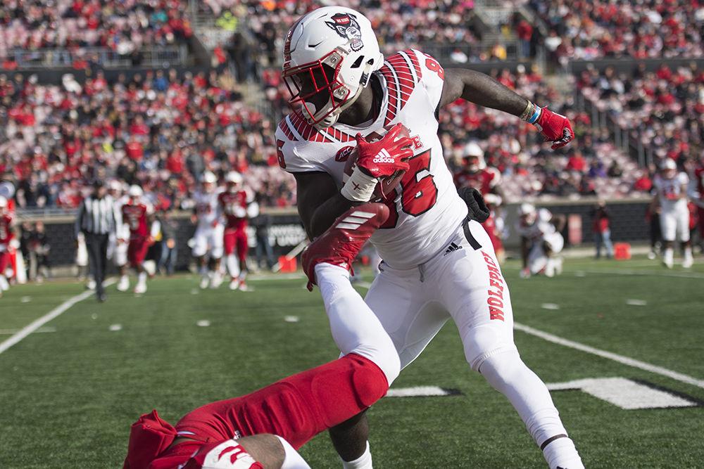 Sophomore wide receiver Emeka Emezie dodges a tackle at&#160;Cardinal Stadium, Saturday, Nov. 17. The Pack flew past the Cardinals, 52-10.&#160;