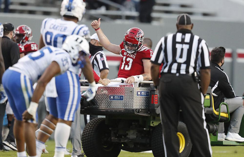 N.C. State quarterback Devin Leary (13) gives a thumbs-up as he is taken off the field after being injured during the second half of N.C. State&#8217;s 31-20 victory over Duke at Carter-Finley Stadium in Raleigh, N.C., Saturday, Oct. 17, 2020.
