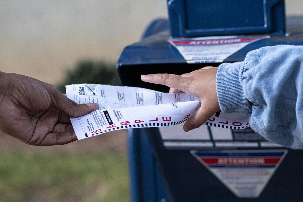 A ballot gets stopped before it gets placed into a mailbox outside of Poe Hall on Wednesday, Oct. 14th, 2020.