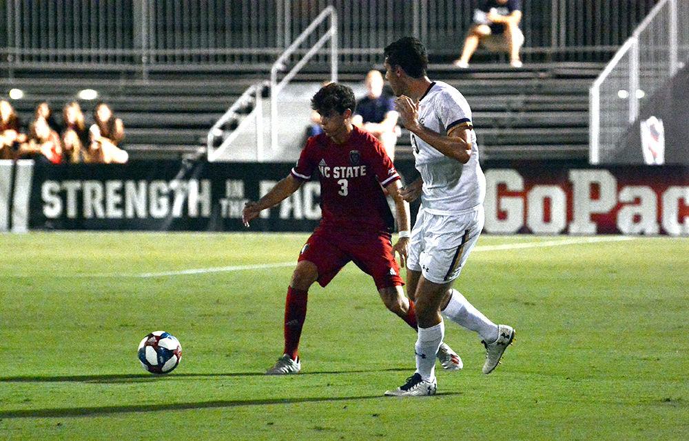 Sophomore defender Pepe Garcia dribbles the ball against Notre Dame player during the NC State men&#8217;s soccer game against Notre Dame on Friday, Oct. 4, 2019 at Dail Soccer Stadium. NC State beat Notre Dame 2-0.