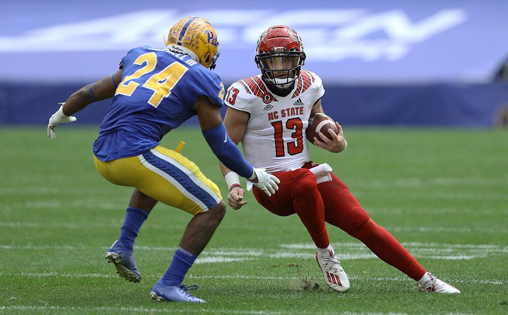 Oct 3, 2020; Pittsburgh, Pennsylvania, USA; Pittsburgh Panthers linebacker Phil Campbell III (24) sacks North Carolina State Wolfpack quarterback Devin Leary (13) during the first quarter at Heinz Field. Mandatory Credit: Charles LeClaire-USA TODAY Sports