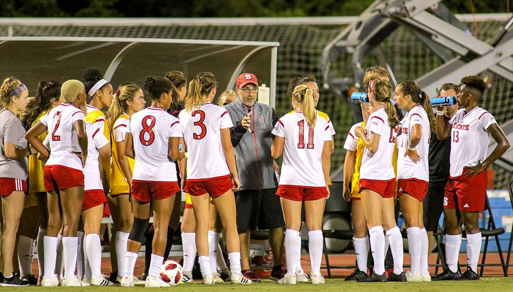 Head coach Tim Santoro talks to the team during an injury time out. The Wolfpack was strong on offense with 29 shots in 110 minutes of play, but was not able to capitalize coming away with a 1-1 draw against East Carolina on Thursday, August 23 in Dail Soccer Stadium.