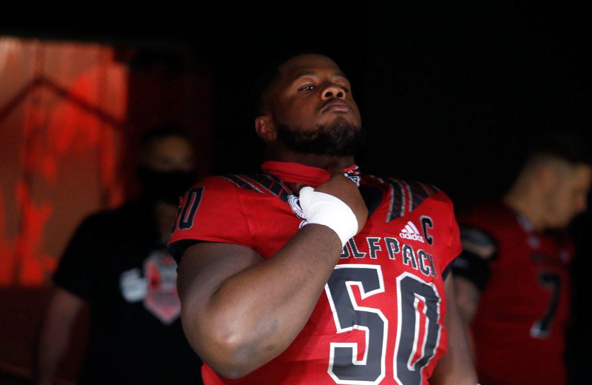 N.C. State center Grant Gibson (50) prepares to head onto the field to warmup before N.C. State&#8217;s game against Florida State at Carter-Finley Stadium in Raleigh, N.C., Saturday, Nov. 14, 2020.