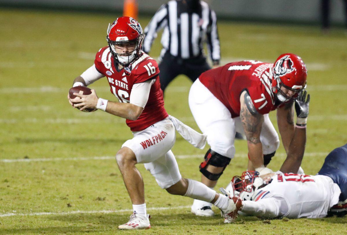 N.C. State quarterback Bailey Hockman (16) escapes from pressure during the first half of N.C. State&#8217;s game against Liberty at Carter-Finley Stadium in Raleigh, N.C., Saturday, Nov. 21, 2020.