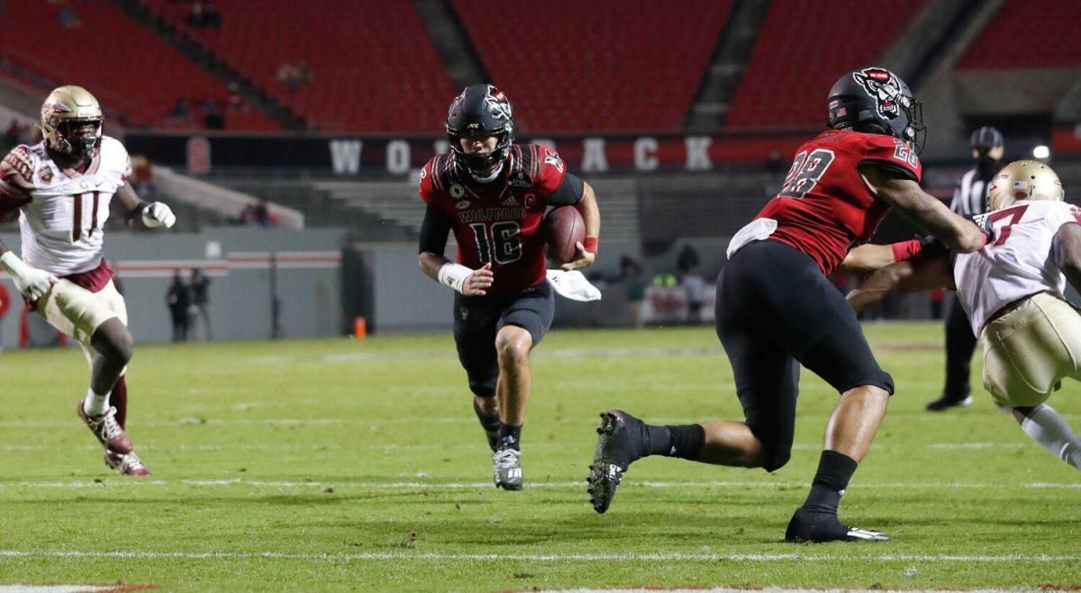 N.C. State quarterback Bailey Hockman (16) scores a touchdown on a 4-yard run during the first half of N.C. State&#8217;s game against Florida State at Carter-Finley Stadium in Raleigh, N.C., Saturday, Nov. 14, 2020.