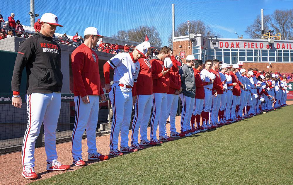 The Wolfpack Baseball team stands in a line in preparation for the national anthem prior to the game against James Madison University on Saturday, Feb. 15, 2020. This game was the second of NC State's three-game series against James Madison University.