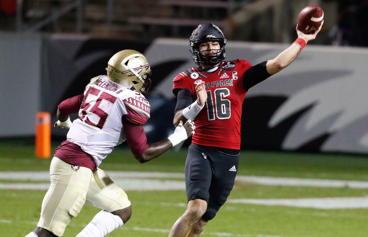 N.C. State quarterback Bailey Hockman (16) throws as Florida State defensive end Derrick McLendon II (55) pressures him during the first half of N.C. State&#8217;s game against Florida State at Carter-Finley Stadium in Raleigh, N.C., Saturday, Nov. 14, 2020.