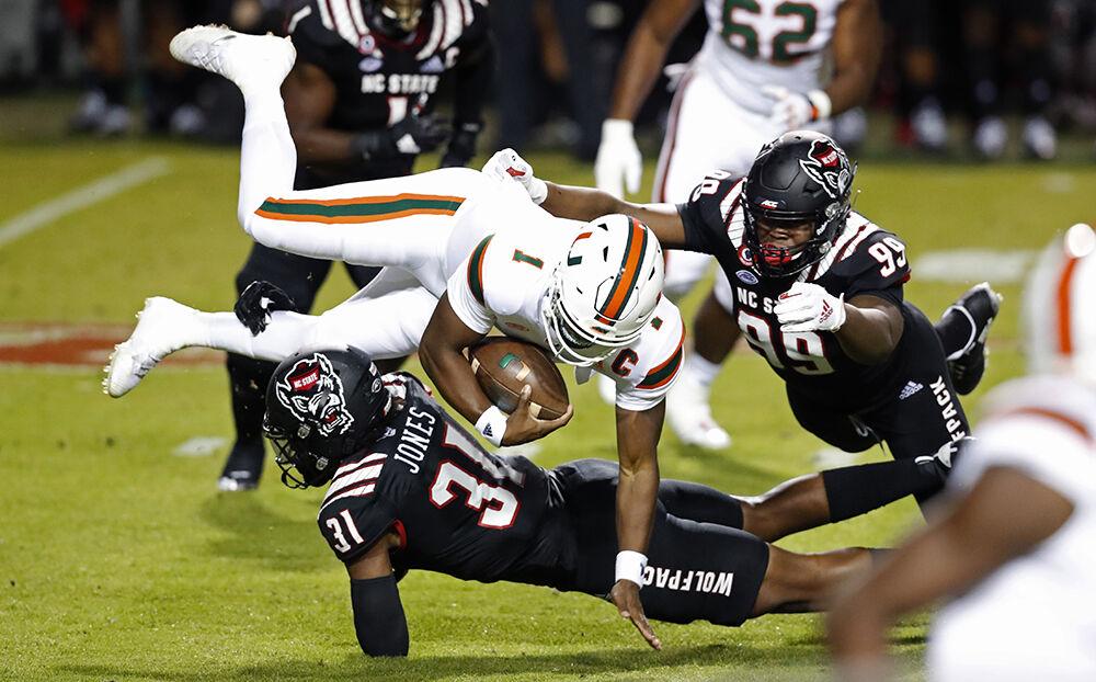 N.C. State linebacker Vi Jones (31) sacks Miami quarterback D'Eriq King (1) during the first half of N.C. State&#8217;s game against Miami at Carter-Finley Stadium in Raleigh, N.C., Friday, Nov. 6, 2020.