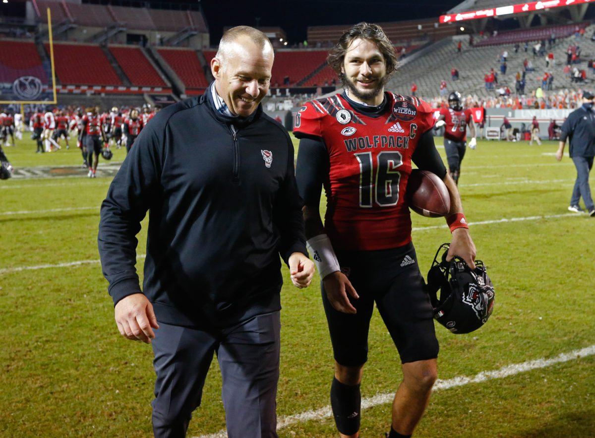 N.C. State head coach Dave Doeren laughs with quarterback Bailey Hockman (16) after N.C. State&#8217;s 38-22 victory over Florida State at Carter-Finley Stadium in Raleigh, N.C., Saturday, Nov. 14, 2020.